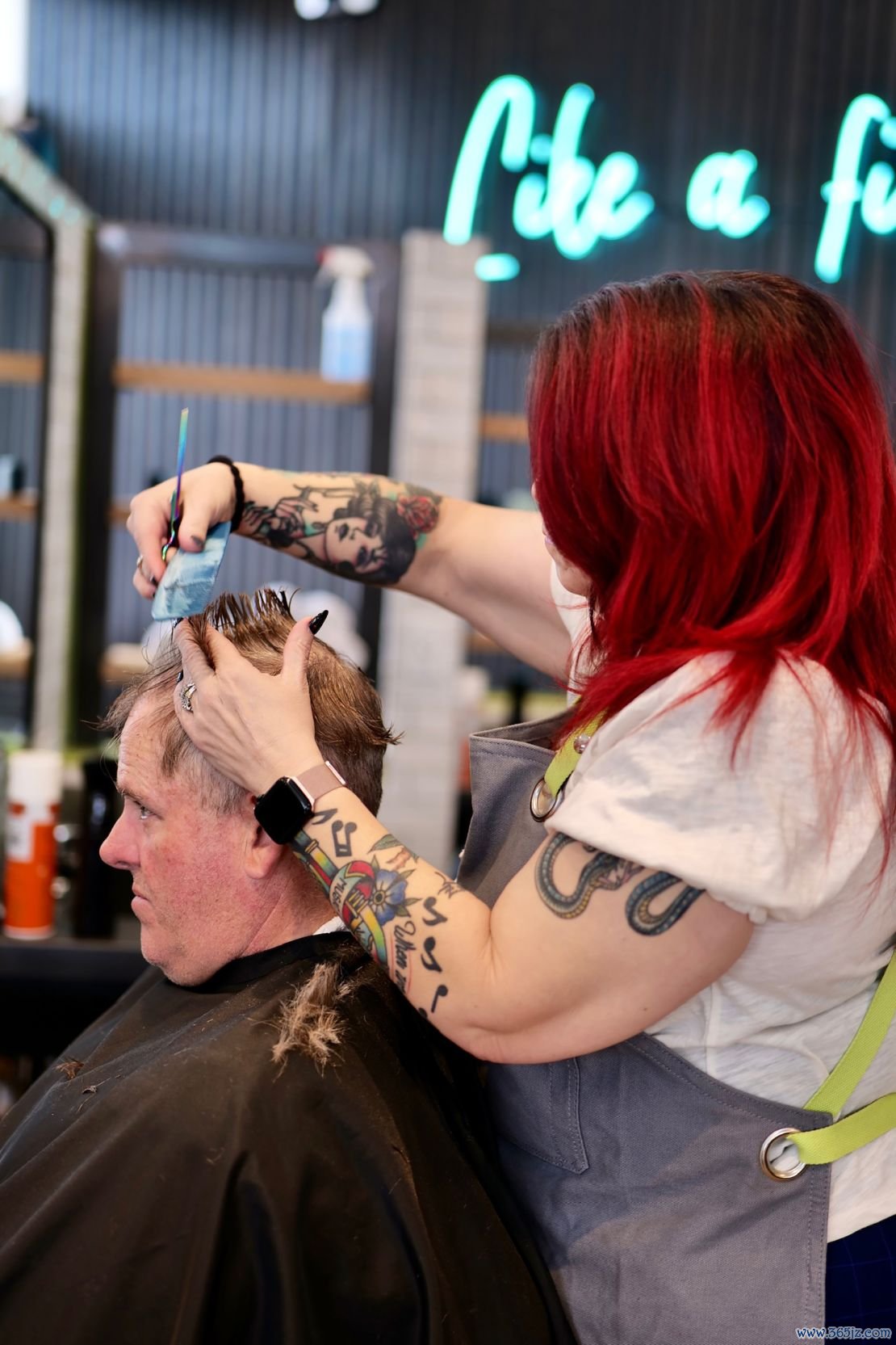 A barber cuts hair at R&R Hair Labs.