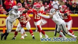 Dec 25, 2023; Kansas City, Missouri, USA; Kansas City Chiefs quarterback Patrick Mahomes (15) scrambles from Las Vegas Raiders defensive tackle Adam Butler (69) and defensive end Tyree Wilson (9) during the second half at GEHA Field at Arrowhead Stadium.