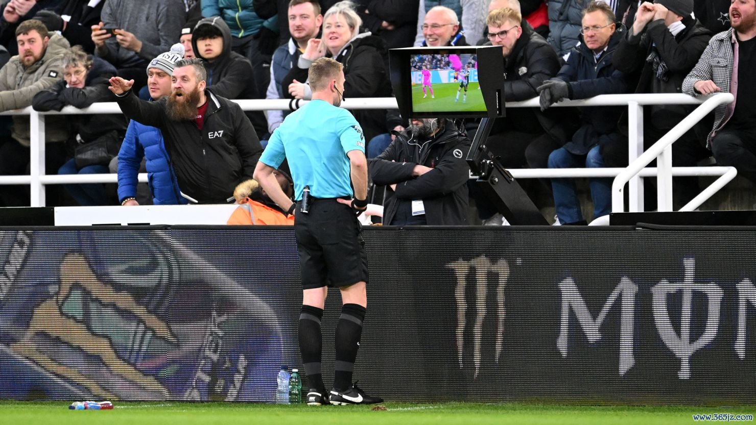 Referee Samuel Barrott checks the pitch-side video assistant referee screen to review a yellow card given to Raúl Jiménez of Fulham during the Premier League match against Newcastle United on December 16, 2023.